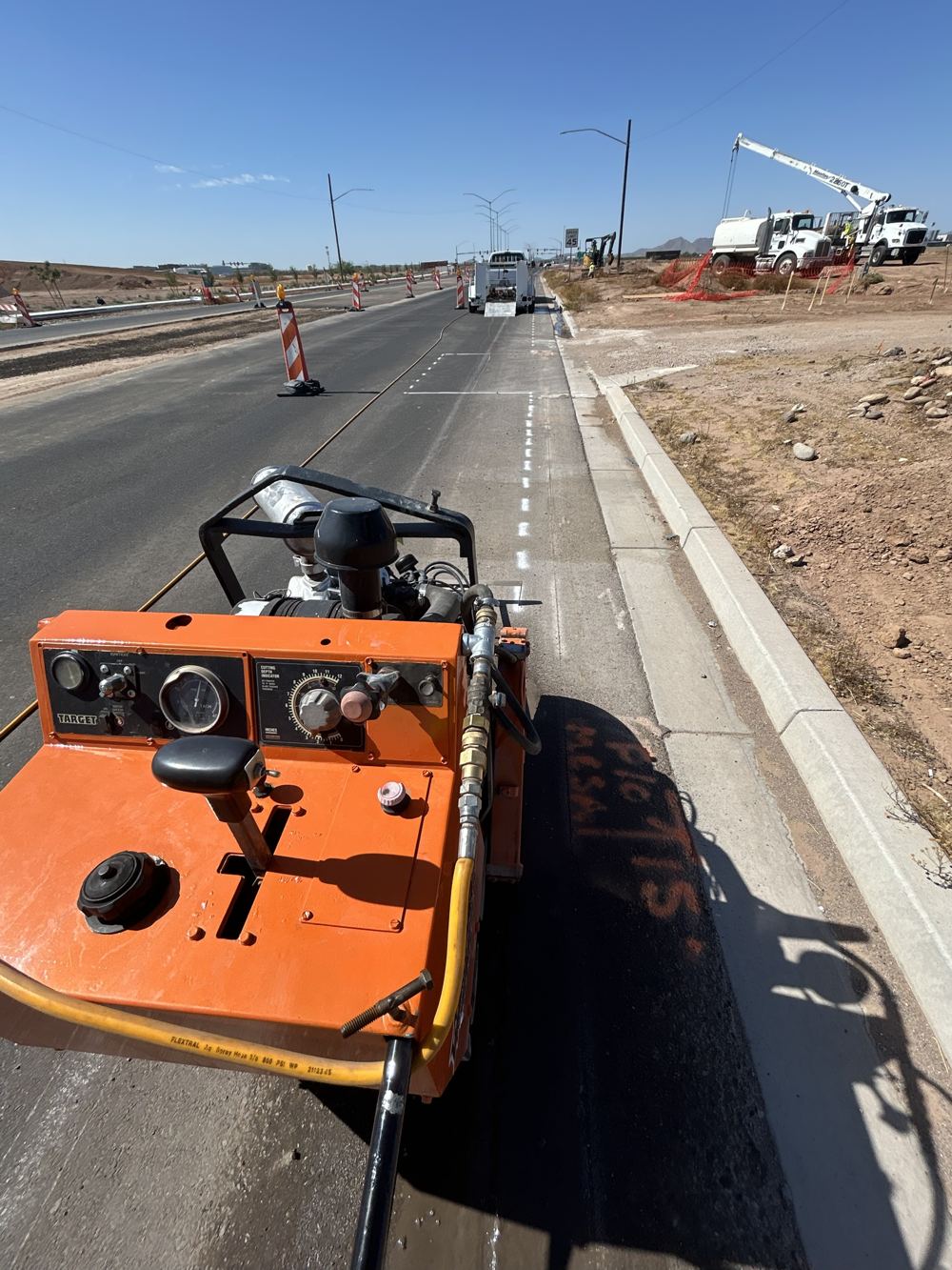 Walk-behind saw cutting asphalt along a new roadway