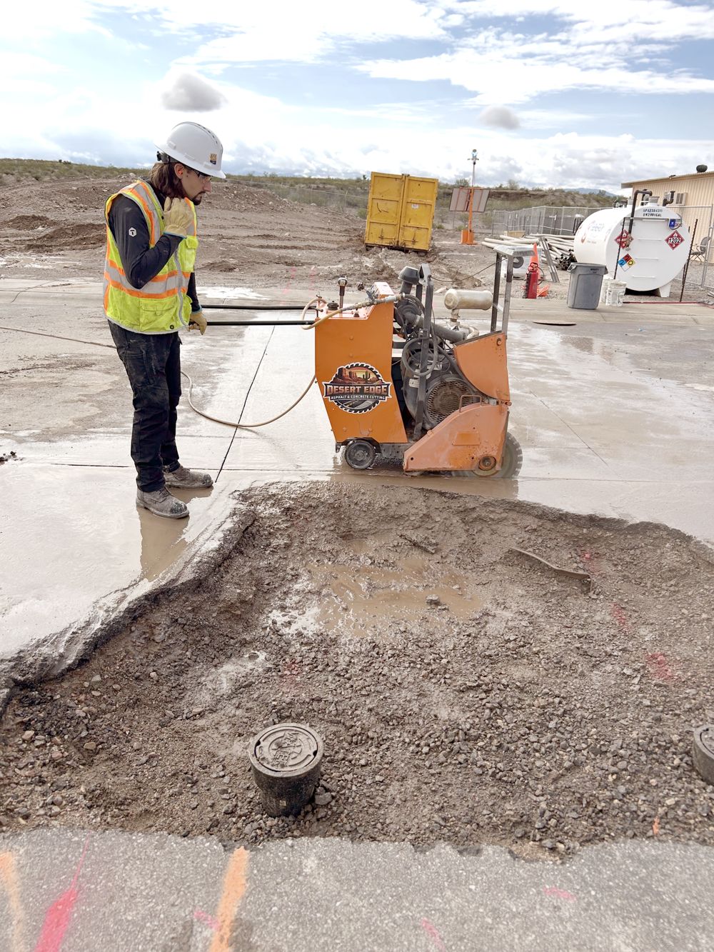 Desert Edge operator saw cutting a concrete slab on a commercial site
