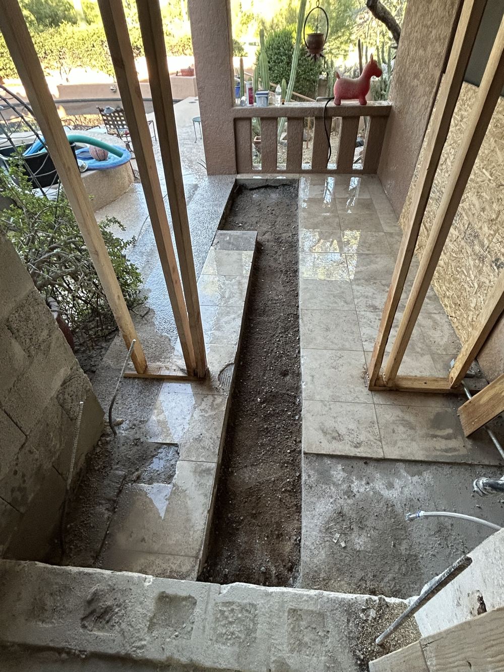Clean trench cut through a tiled concrete patio slab