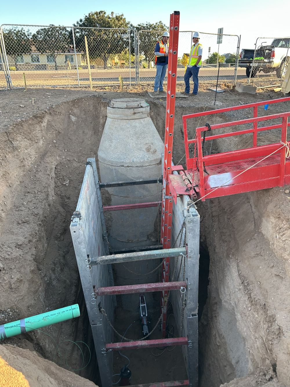 Shored trench around a concrete utility vault